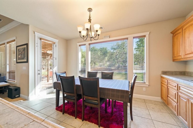 tiled dining room with crown molding and a chandelier