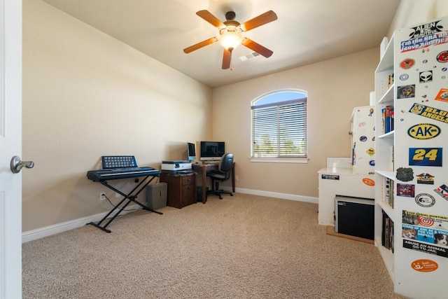 carpeted office space with ceiling fan