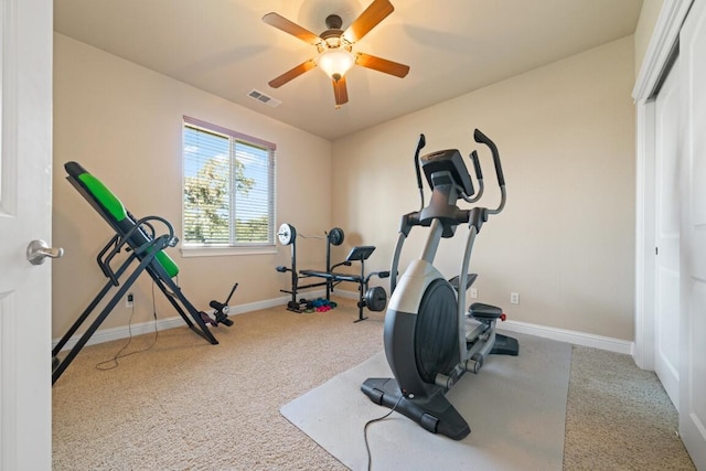 exercise room featuring ceiling fan and light colored carpet