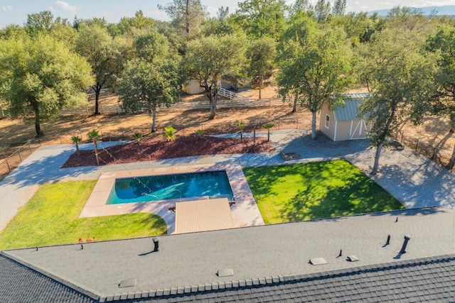 view of swimming pool featuring a yard and a patio area