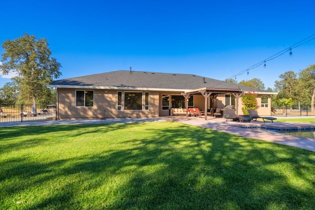 back of property with a yard and a patio