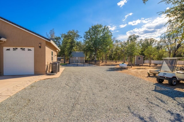 view of yard with a garage and a storage shed