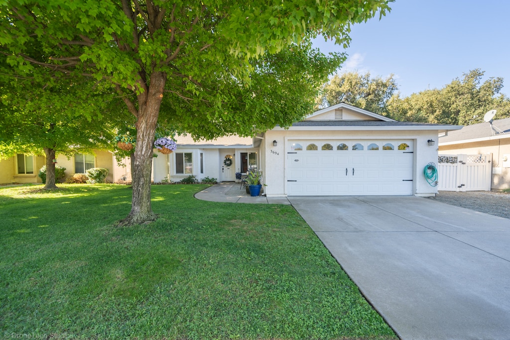 ranch-style home featuring a front yard and a garage