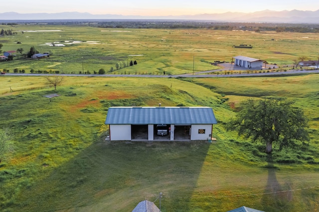 aerial view at dusk with a mountain view and a rural view