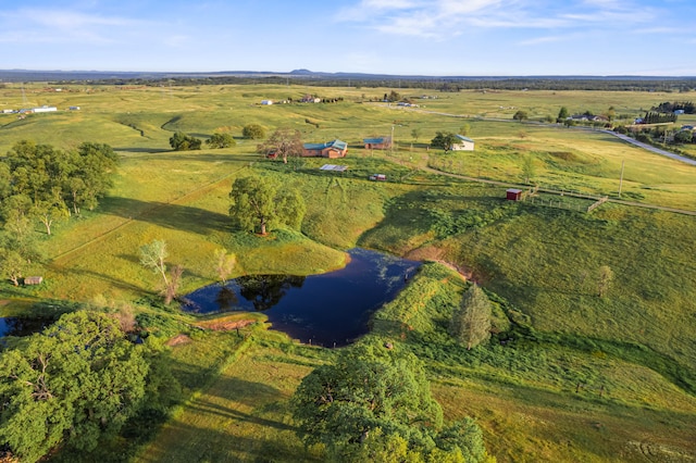 birds eye view of property featuring a rural view and a water view