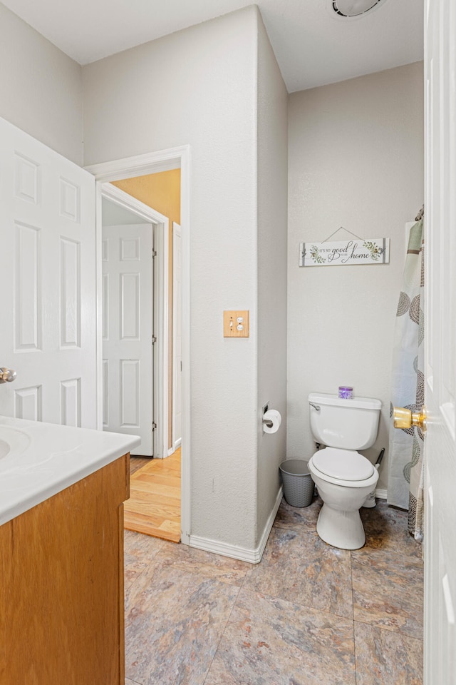 bathroom featuring toilet and vanity