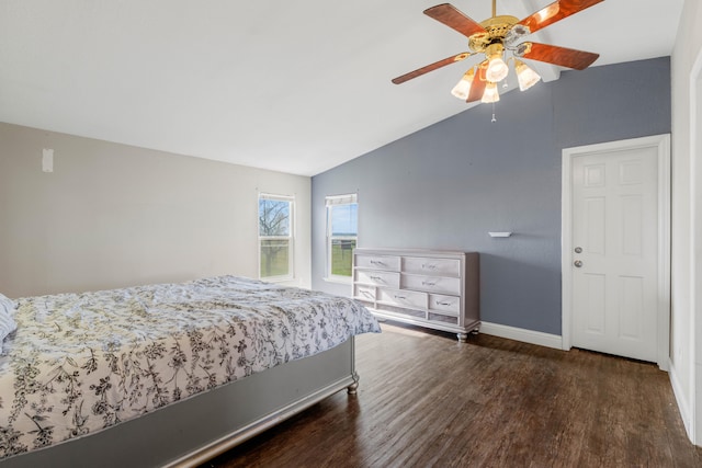 bedroom with ceiling fan, vaulted ceiling, and dark hardwood / wood-style floors