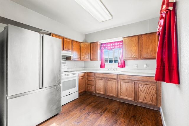 kitchen with white electric range oven, stainless steel fridge, dark hardwood / wood-style flooring, and sink