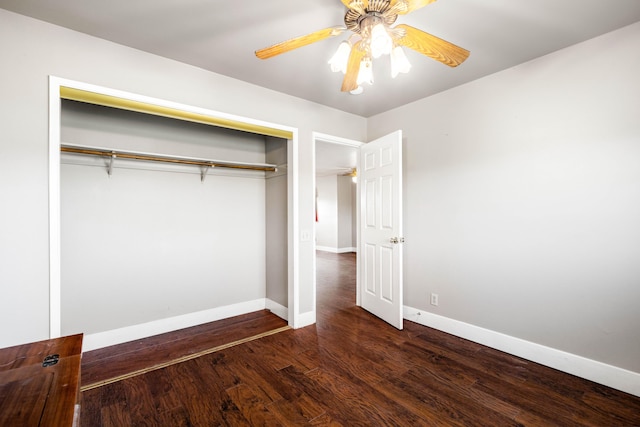 unfurnished bedroom with a closet, dark hardwood / wood-style flooring, and ceiling fan