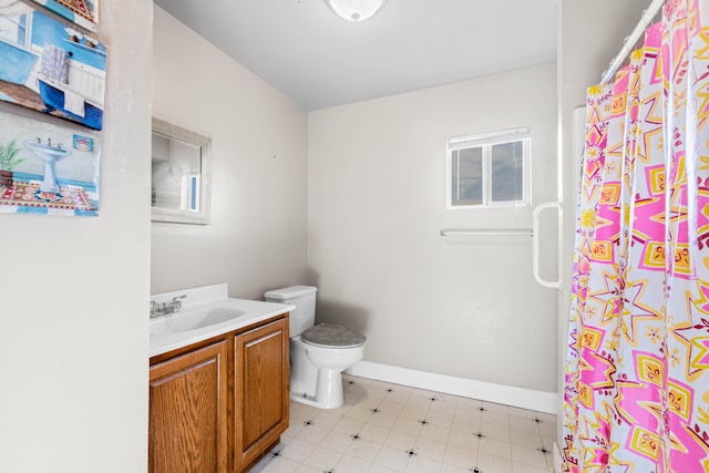 bathroom featuring vanity, toilet, and curtained shower