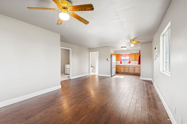 unfurnished living room with ceiling fan and dark hardwood / wood-style floors