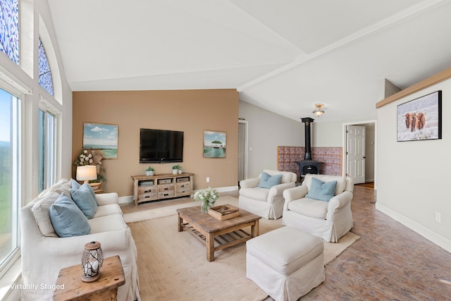 living room featuring light carpet, lofted ceiling, and a wood stove