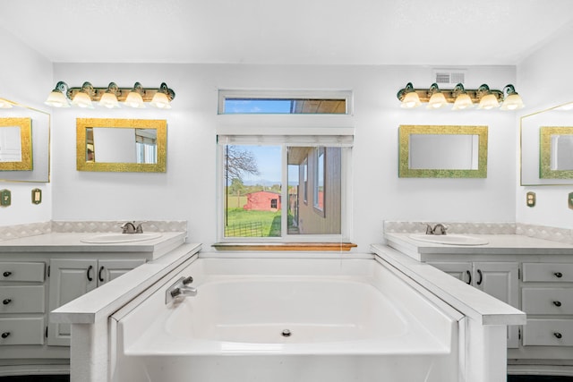 bathroom with a tub and vanity