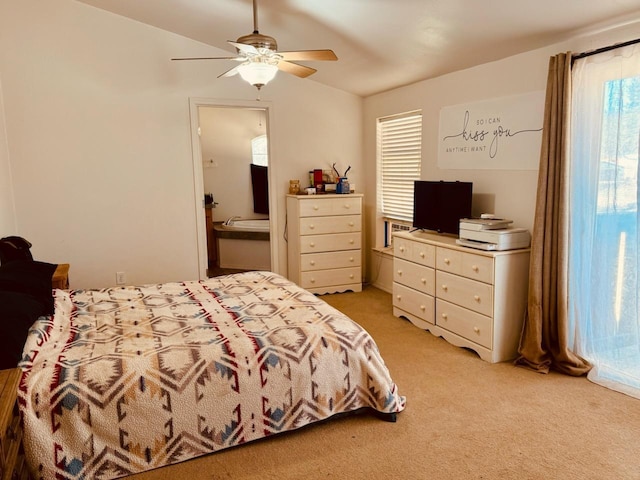 bedroom with ceiling fan, ensuite bath, and light carpet