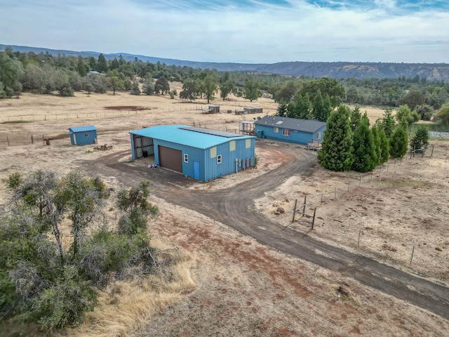 birds eye view of property with a mountain view and a rural view