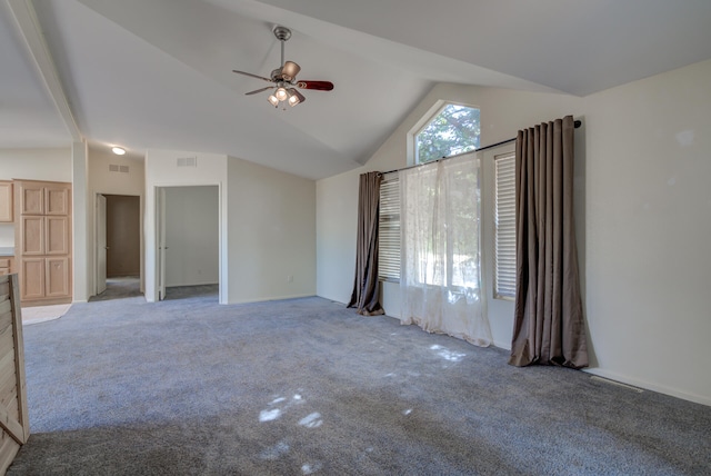 unfurnished living room with high vaulted ceiling, ceiling fan, and light colored carpet