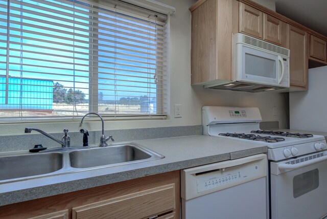 kitchen featuring white appliances, sink, and light brown cabinets