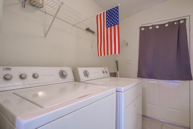 washroom featuring light tile patterned flooring and separate washer and dryer