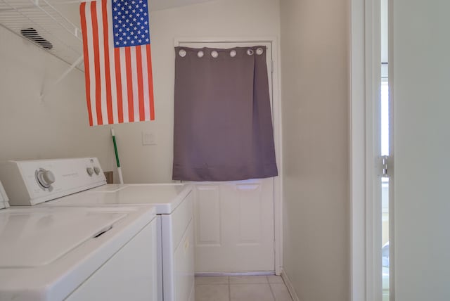 washroom featuring light tile patterned flooring and separate washer and dryer