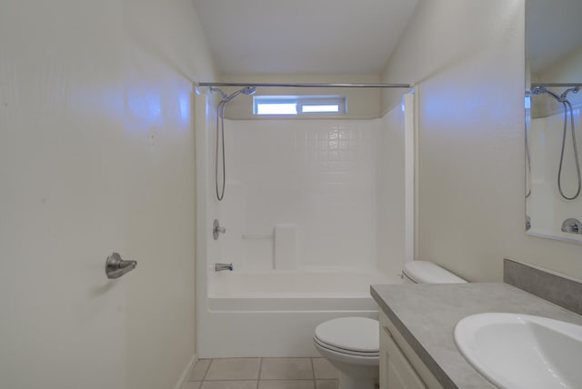 full bathroom featuring tile patterned flooring, toilet,  shower combination, lofted ceiling, and vanity