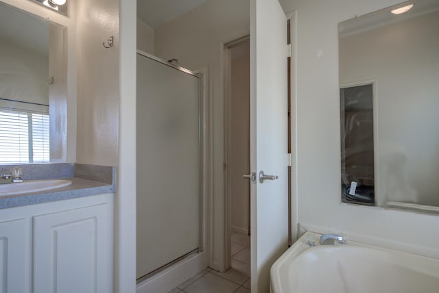 bathroom featuring tile patterned flooring, vanity, and shower with separate bathtub