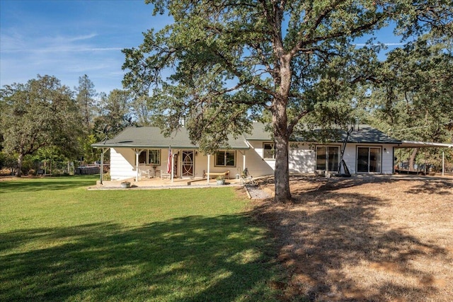 rear view of house with a yard and a patio area