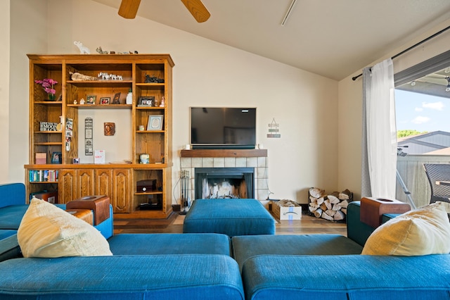 living room with hardwood / wood-style flooring, a fireplace, ceiling fan, and vaulted ceiling