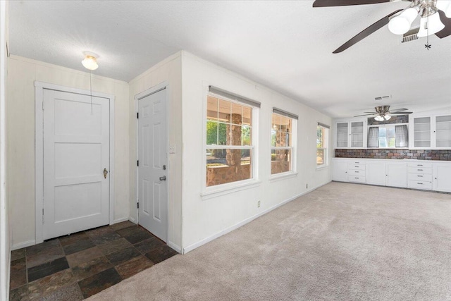 interior space with dark carpet and a textured ceiling