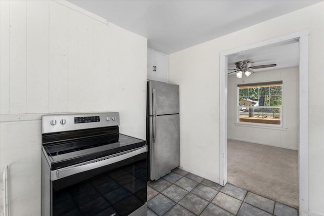 kitchen featuring carpet floors, ceiling fan, white cabinets, and stainless steel appliances