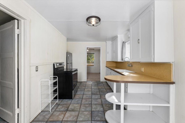 kitchen featuring stainless steel appliances, white cabinetry, and sink