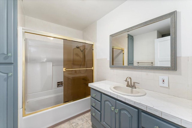 bathroom with tile patterned flooring, vanity, shower / bathtub combination, and decorative backsplash