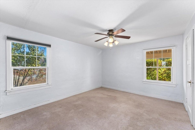 empty room featuring light colored carpet and ceiling fan