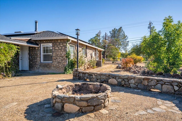 exterior space featuring an outdoor fire pit