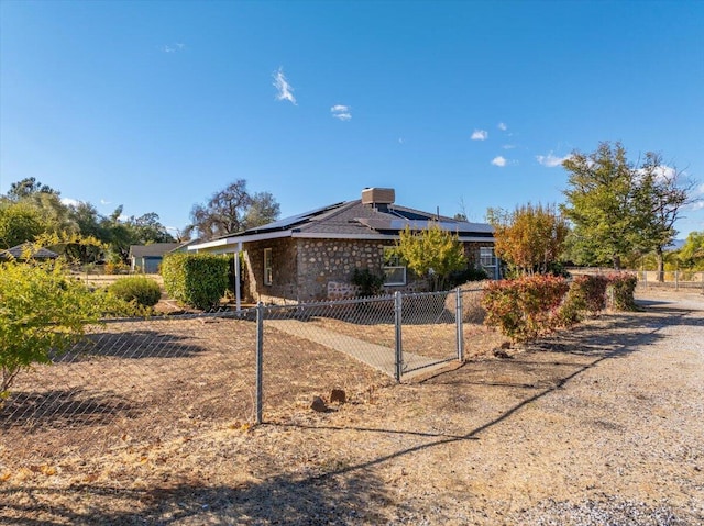 ranch-style house featuring solar panels