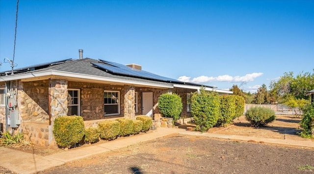 view of front of property with solar panels