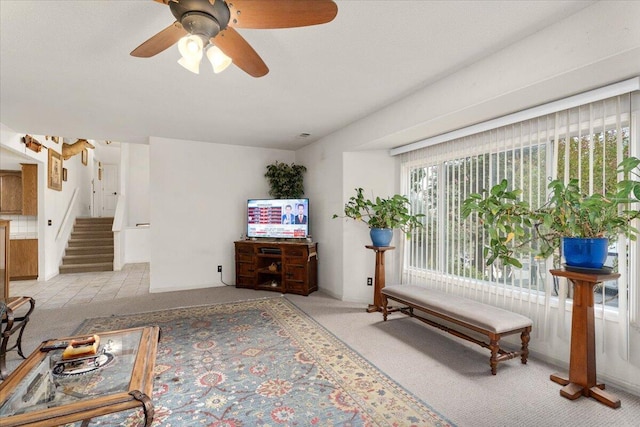 living room with light carpet, a wealth of natural light, and ceiling fan