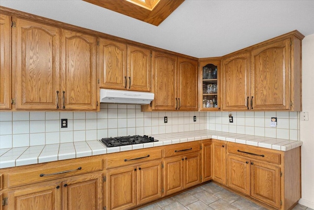 kitchen with gas cooktop, tile countertops, and backsplash