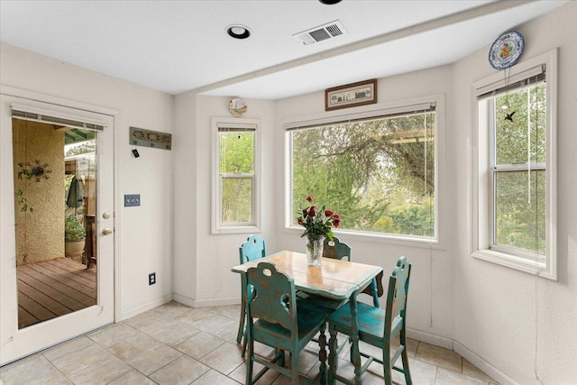 tiled dining area featuring a healthy amount of sunlight