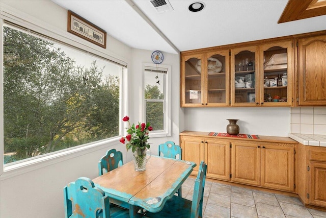 dining area with light tile patterned flooring and a wealth of natural light