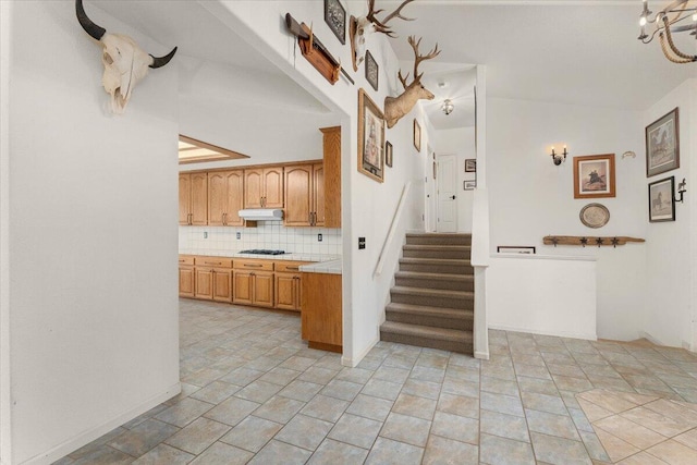 kitchen with decorative backsplash, black gas cooktop, and light tile patterned floors