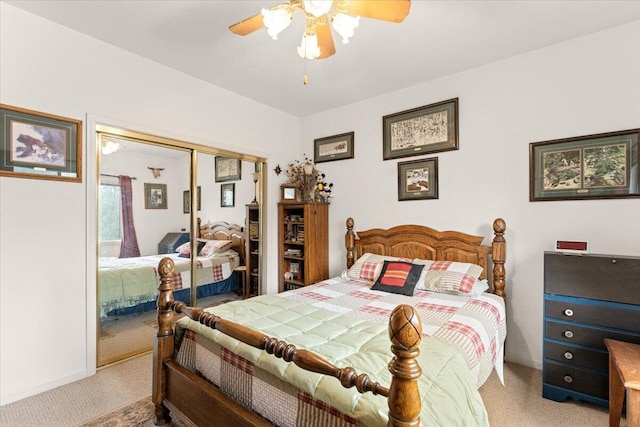 bedroom with ceiling fan, a closet, and light colored carpet