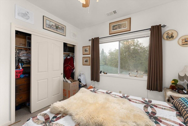 bedroom with ceiling fan, a closet, and carpet flooring