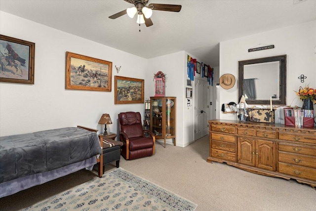 bedroom featuring light carpet and ceiling fan