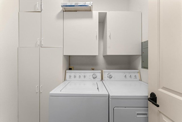 washroom featuring cabinets and washing machine and dryer