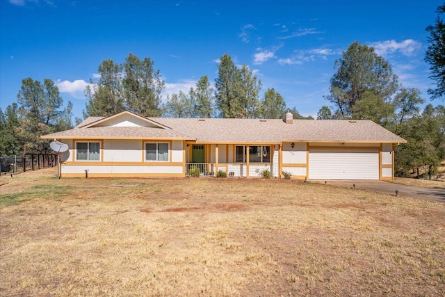 single story home featuring a garage, a porch, and a front lawn