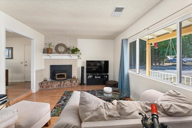 living room with plenty of natural light, hardwood / wood-style floors, and a textured ceiling