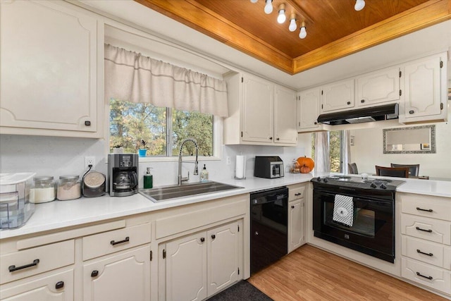 kitchen with white cabinetry, black appliances, and a healthy amount of sunlight