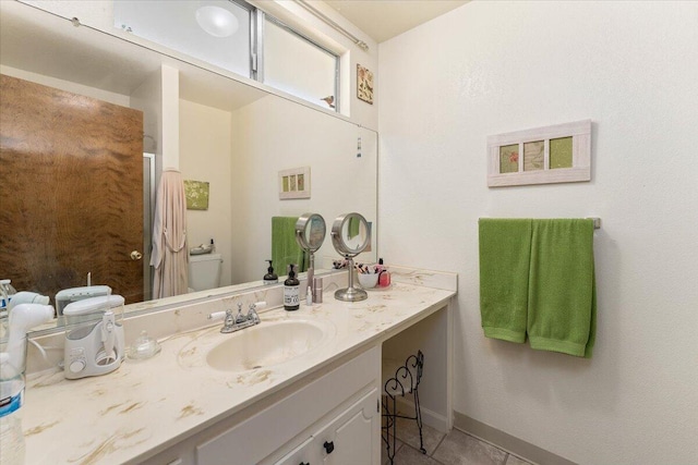 bathroom with vanity, tile patterned flooring, and toilet