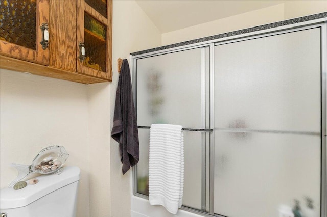 bathroom featuring walk in shower and toilet