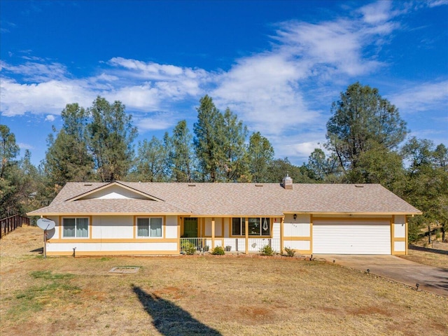 ranch-style house featuring a porch, a front yard, and a garage